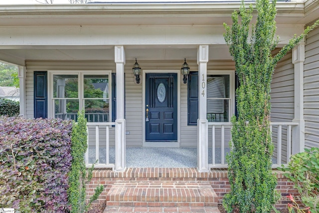 view of exterior entry featuring a porch