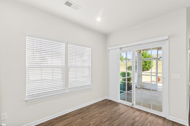 unfurnished room with recessed lighting, wood finished floors, visible vents, and baseboards