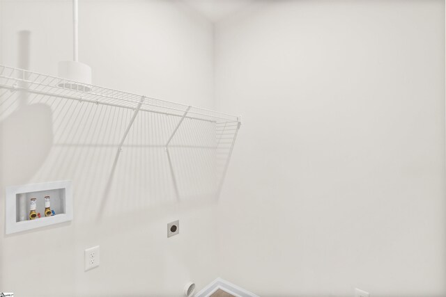 clothes washing area featuring baseboards, laundry area, hookup for an electric dryer, and hookup for a washing machine
