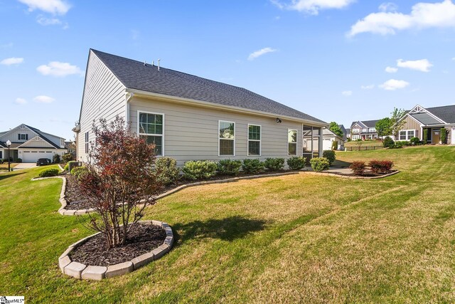 back of property with a lawn