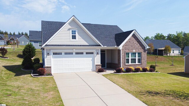 view of front of property with brick siding, roof with shingles, driveway, and a front yard