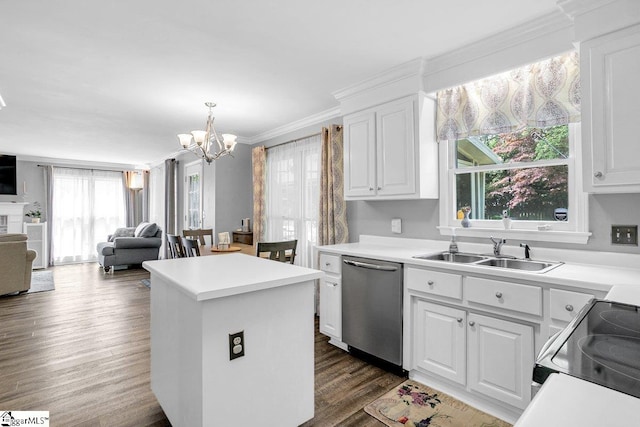 kitchen featuring stainless steel appliances, a center island, a sink, open floor plan, and a notable chandelier