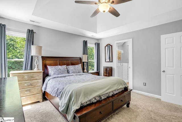 carpeted bedroom featuring ceiling fan, baseboards, multiple windows, and visible vents