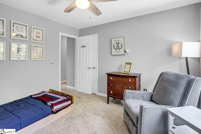 bedroom featuring light carpet, baseboards, and ceiling fan