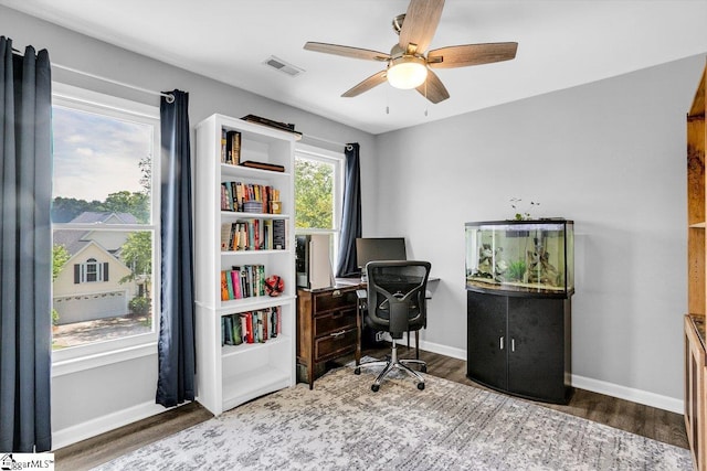 office area with baseboards, a ceiling fan, wood finished floors, and visible vents
