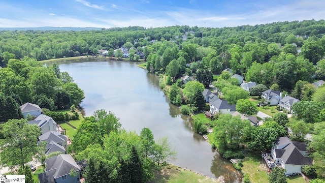 birds eye view of property with a forest view, a water view, and a residential view