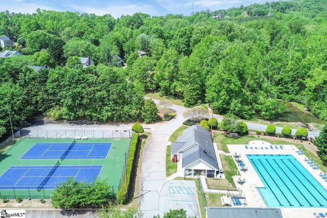 drone / aerial view with a wooded view