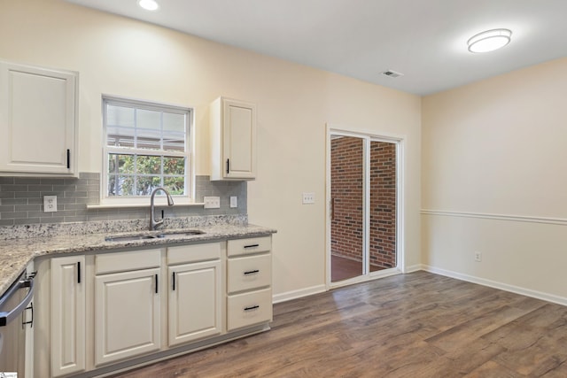kitchen featuring white cabinets, dark wood-type flooring, a sink, and visible vents