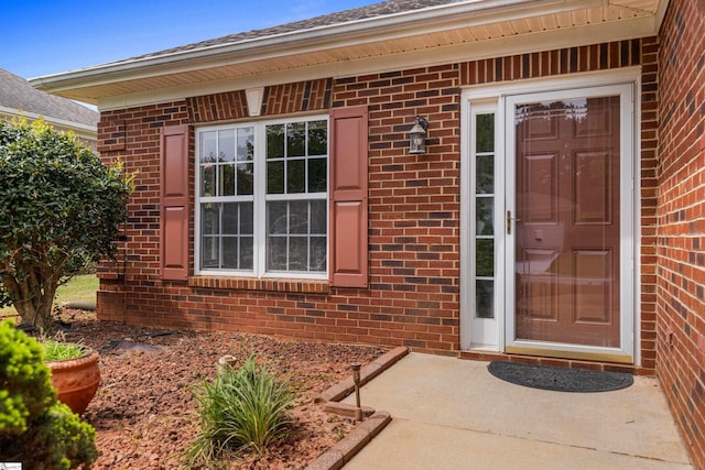 property entrance with brick siding