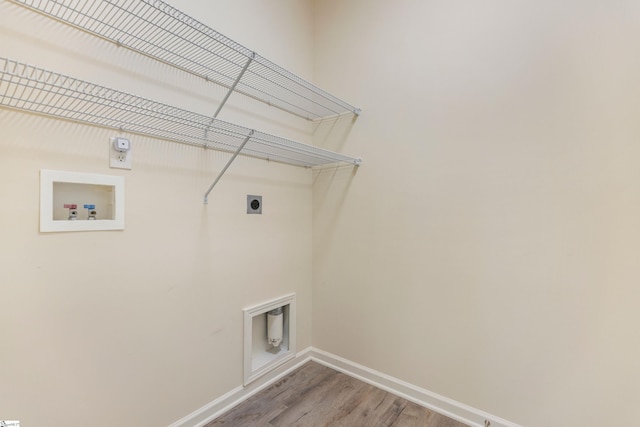 laundry room featuring hookup for a washing machine, hookup for an electric dryer, light wood-style floors, baseboards, and laundry area