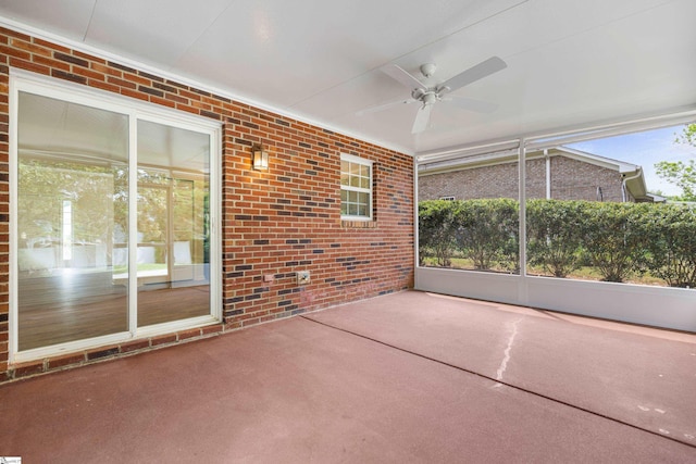 unfurnished sunroom with a ceiling fan