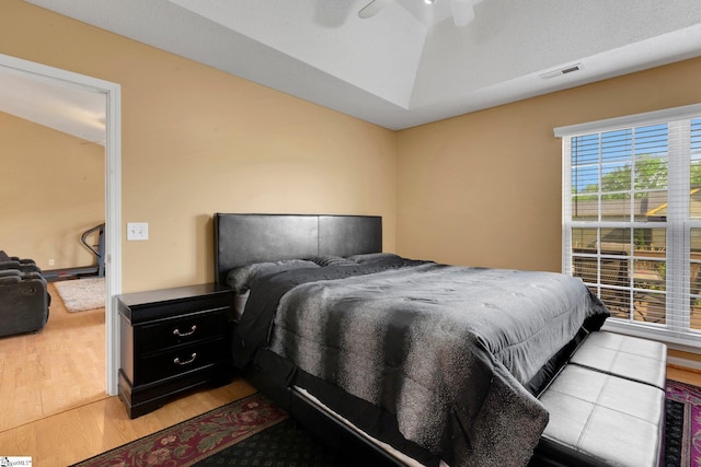 bedroom featuring wood finished floors and visible vents