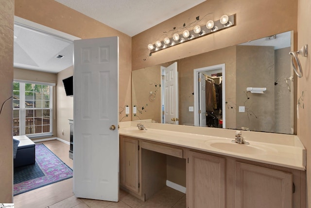 full bathroom with tile patterned flooring, a sink, visible vents, and double vanity
