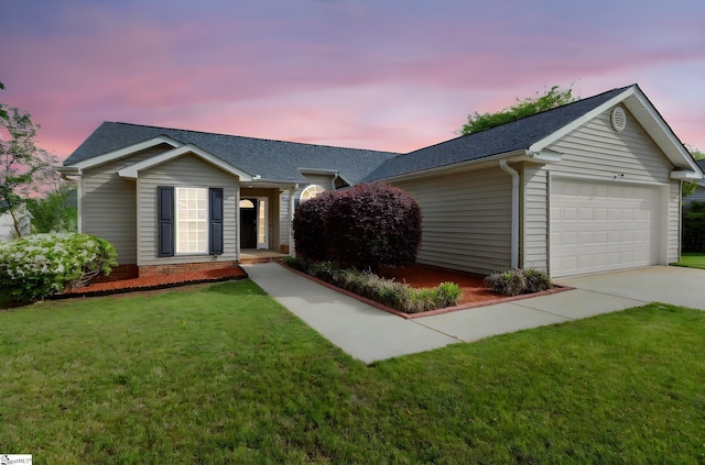 single story home with a garage, driveway, a shingled roof, and a lawn