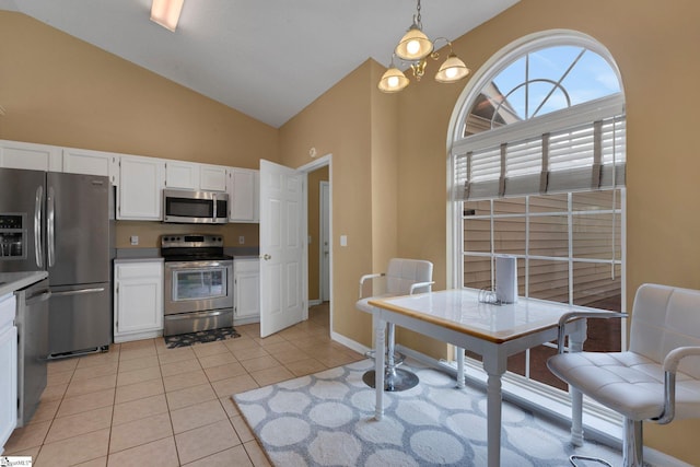 interior space featuring high vaulted ceiling, baseboards, and light tile patterned flooring