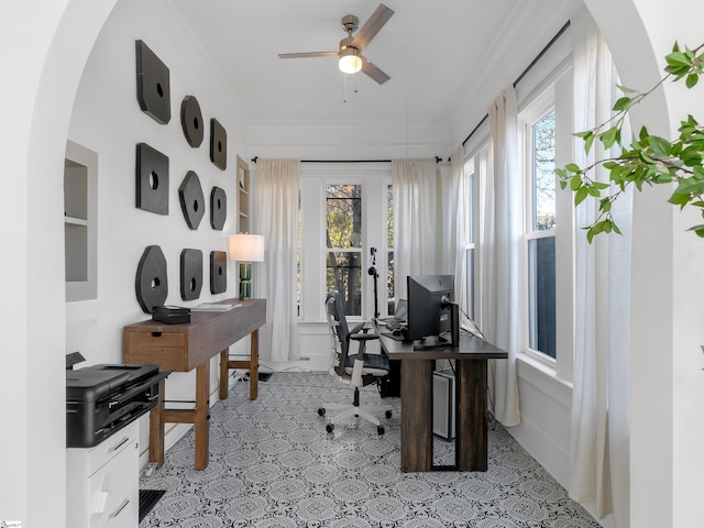 office area with arched walkways, a ceiling fan, and ornamental molding