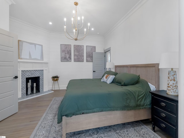 bedroom featuring recessed lighting, wood finished floors, crown molding, and an inviting chandelier