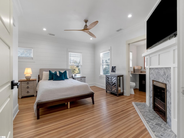 bedroom featuring visible vents, light wood-style floors, and multiple windows
