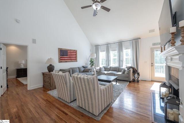 102 Rabon Chase Ct, Fountain Inn, SC 29644 - living area with high vaulted ceiling, a ceiling fan, wood finished floors, a tile fireplace, and visible vents