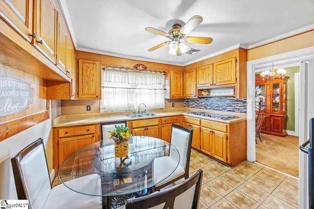 kitchen featuring a sink, stovetop, visible vents, ceiling fan, and light countertops