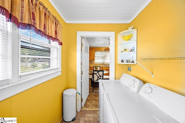 washroom featuring washer and dryer, a sink, and laundry area