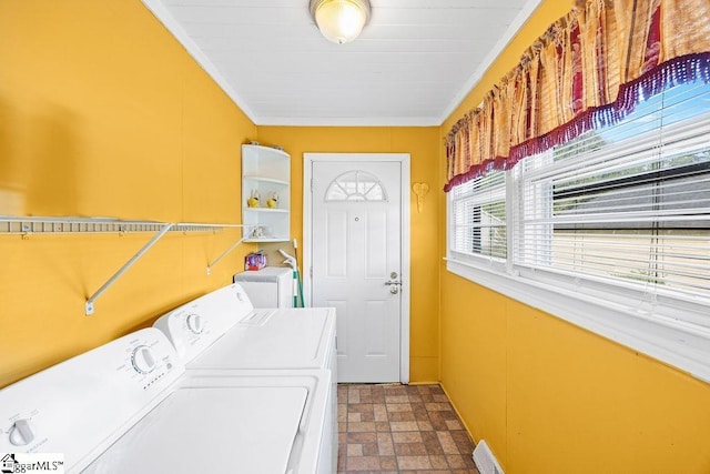 washroom with crown molding, stone finish floor, independent washer and dryer, and laundry area