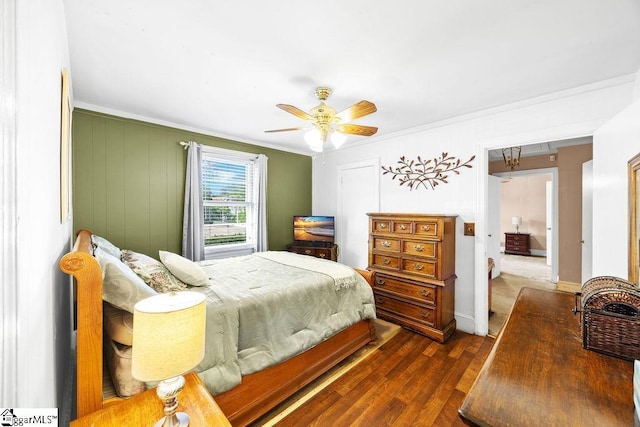 bedroom featuring crown molding, ceiling fan, baseboards, and dark wood-type flooring