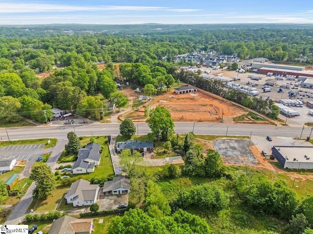 drone / aerial view with a wooded view