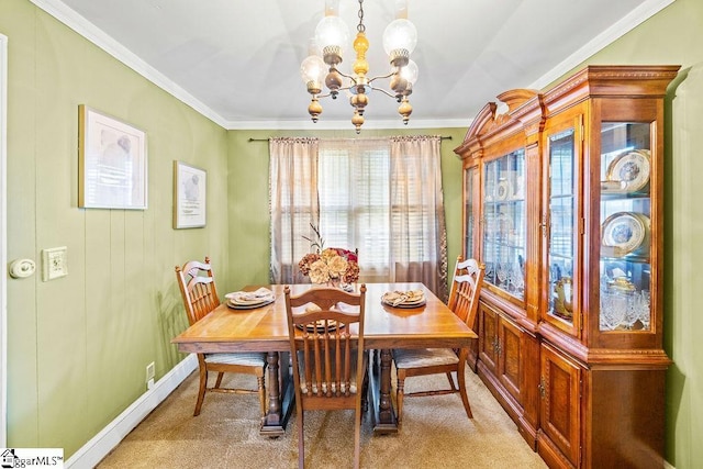 dining area with crown molding, a notable chandelier, baseboards, and light carpet