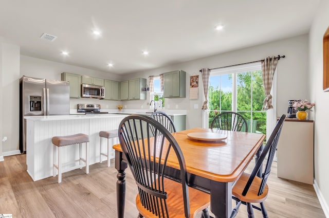 dining room with baseboards, visible vents, light wood-type flooring, and recessed lighting