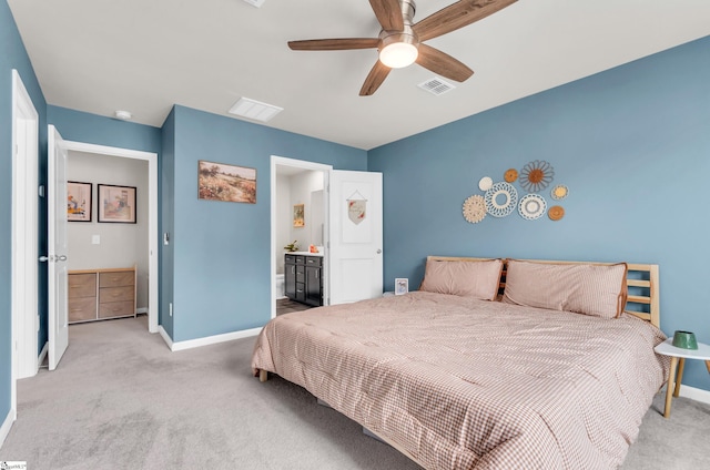 carpeted bedroom featuring baseboards, visible vents, ceiling fan, and ensuite bathroom