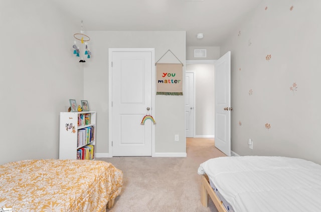 bedroom with visible vents, light colored carpet, and baseboards