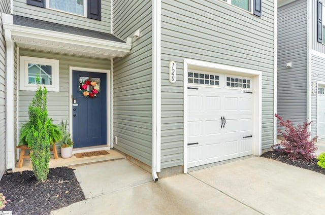 entrance to property featuring an attached garage