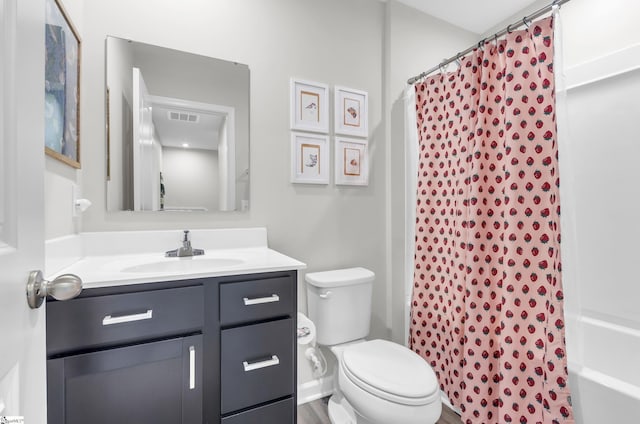 bathroom featuring toilet, visible vents, and vanity
