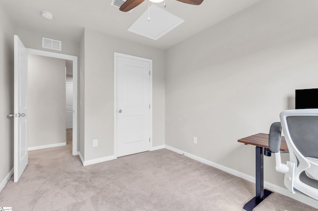 carpeted home office with ceiling fan, baseboards, and visible vents