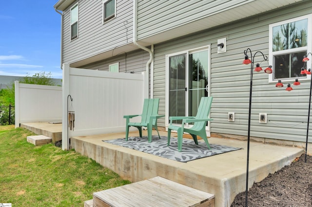 wooden terrace with a patio area and fence
