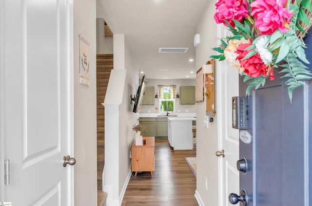 hall with a sink, stairway, visible vents, recessed lighting, and wood finished floors