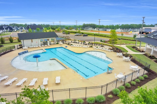 pool featuring fence and a patio area