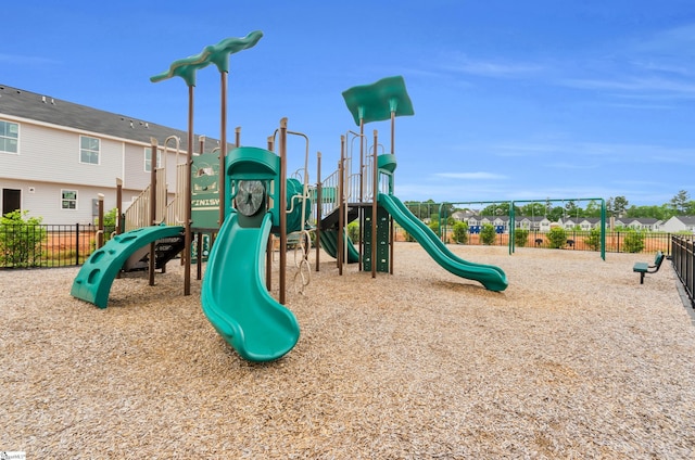 community jungle gym with fence and a residential view