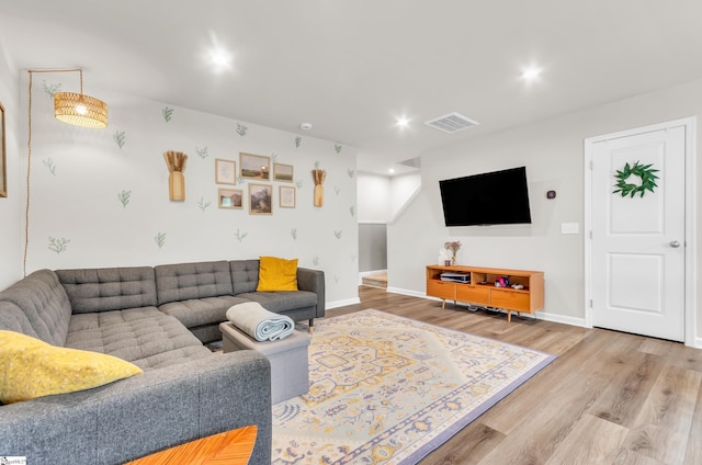 living area featuring wood finished floors, visible vents, recessed lighting, and baseboards