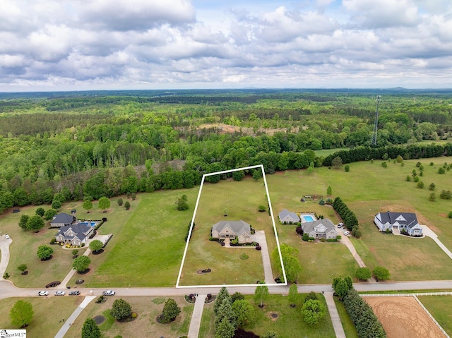 birds eye view of property with a view of trees