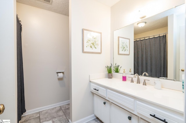 203 W Dr, Travelers Rest, SC 29690 - bathroom featuring a textured ceiling, vanity, and baseboards