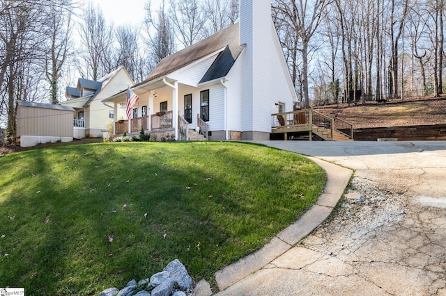 203 W Dr, Travelers Rest, SC 29690 - exterior space featuring a porch, a lawn, stairway, and a chimney