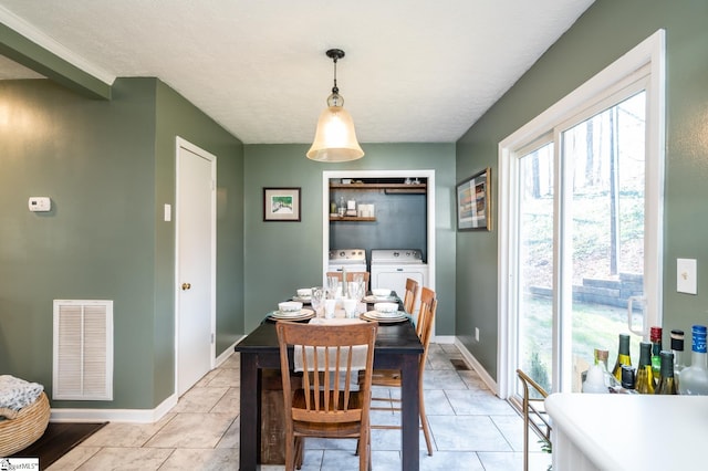 203 W Dr, Travelers Rest, SC 29690 - dining room with baseboards, visible vents, washer and clothes dryer, and plenty of natural light