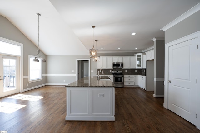 112 Nokota Dr, Pelzer, SC 29669 - kitchen with dark stone counters, white cabinetry, decorative backsplash, a sink, and appliances with stainless steel finishes