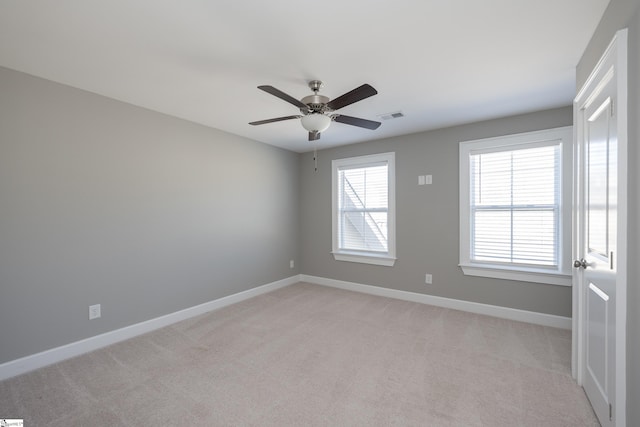 112 Nokota Dr, Pelzer, SC 29669 - spare room featuring light colored carpet, visible vents, ceiling fan, and baseboards