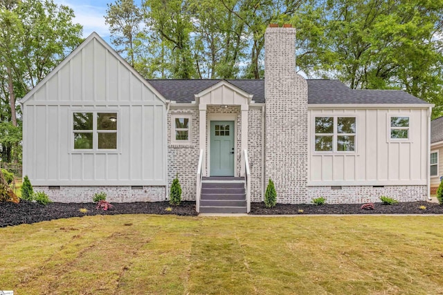 modern farmhouse with a front yard, crawl space, board and batten siding, and roof with shingles