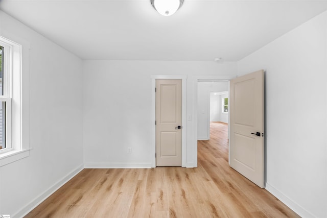 unfurnished bedroom featuring baseboards and light wood-style flooring