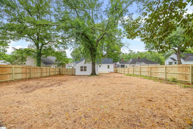 view of yard featuring a fenced backyard and a residential view