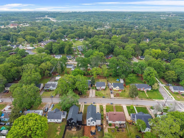 bird's eye view featuring a forest view and a residential view